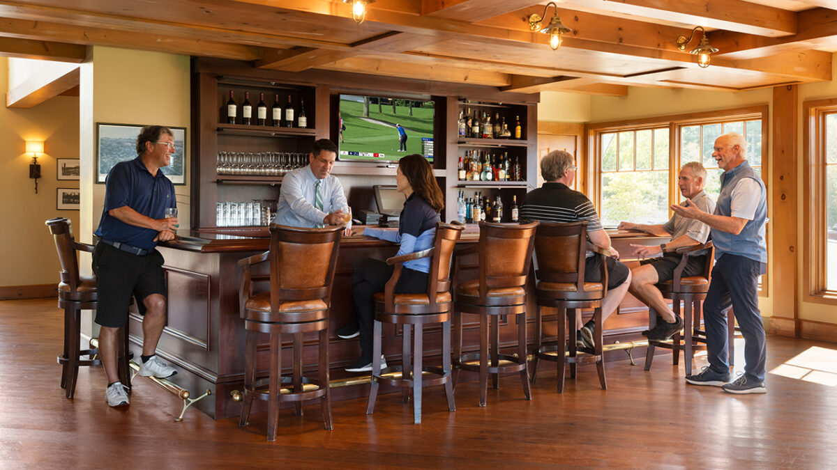 People socializing at the Lake Winnipesaukee Golf Club bar.