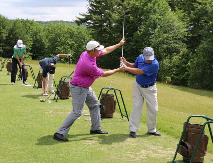 Jason Sedan - golf professional at Lake Winnipesaukee Golf Club teaching on the range.